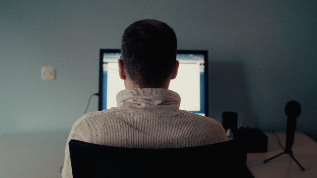 Ertay Shashko sits at the desk where he works as a Senior Salesforce Project Lead at BIT.